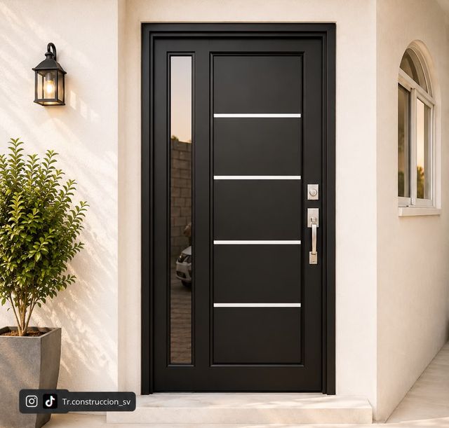 Negra con lateral de vidrio — Tres franjas de inox y un panel lateral fijo que ilumina el zaguán